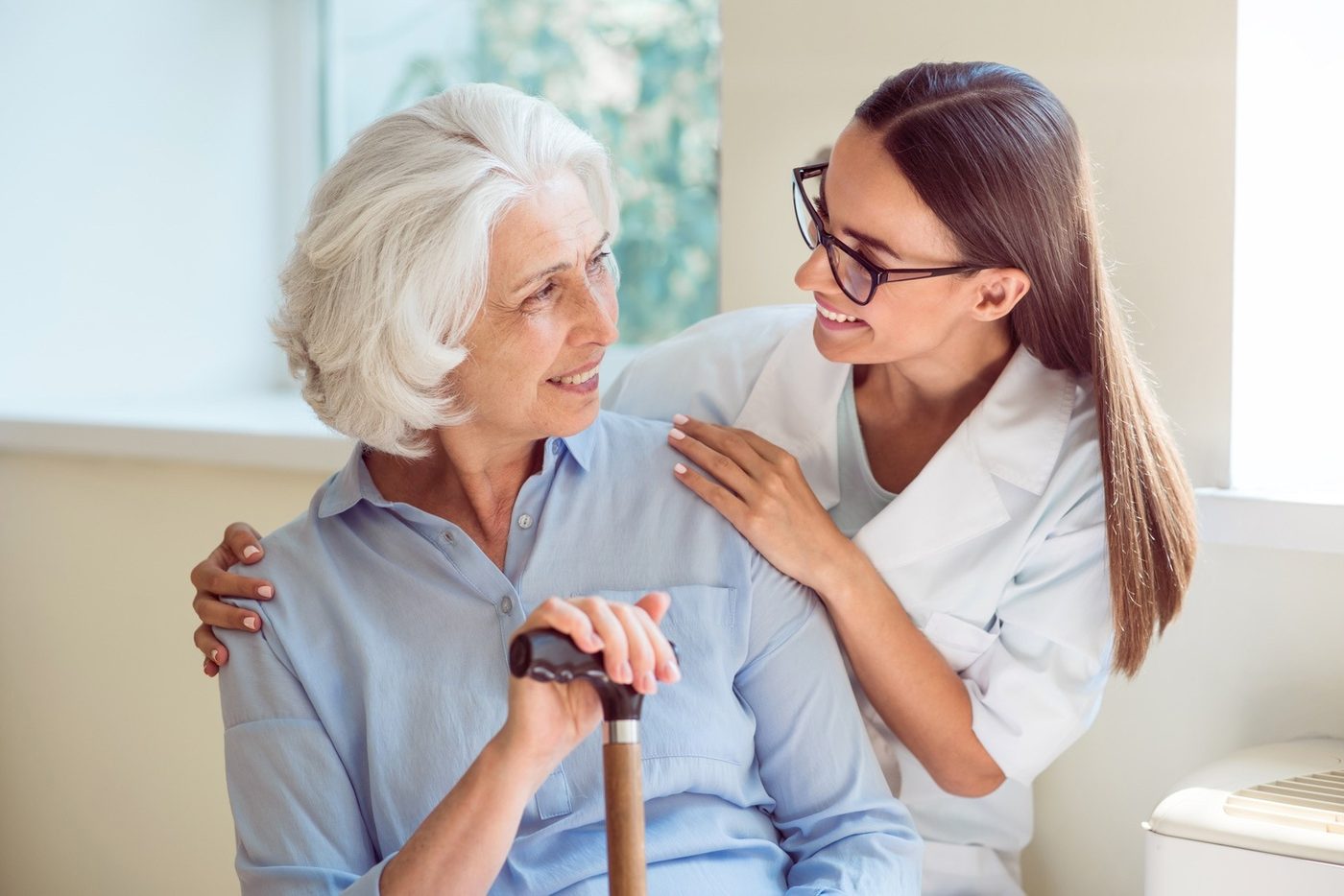 A care manager talking with an elderly client at home