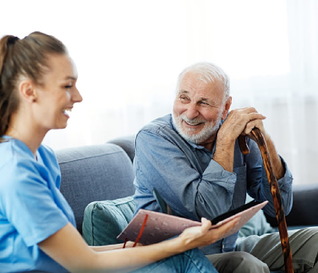 A carer and an older person together at home